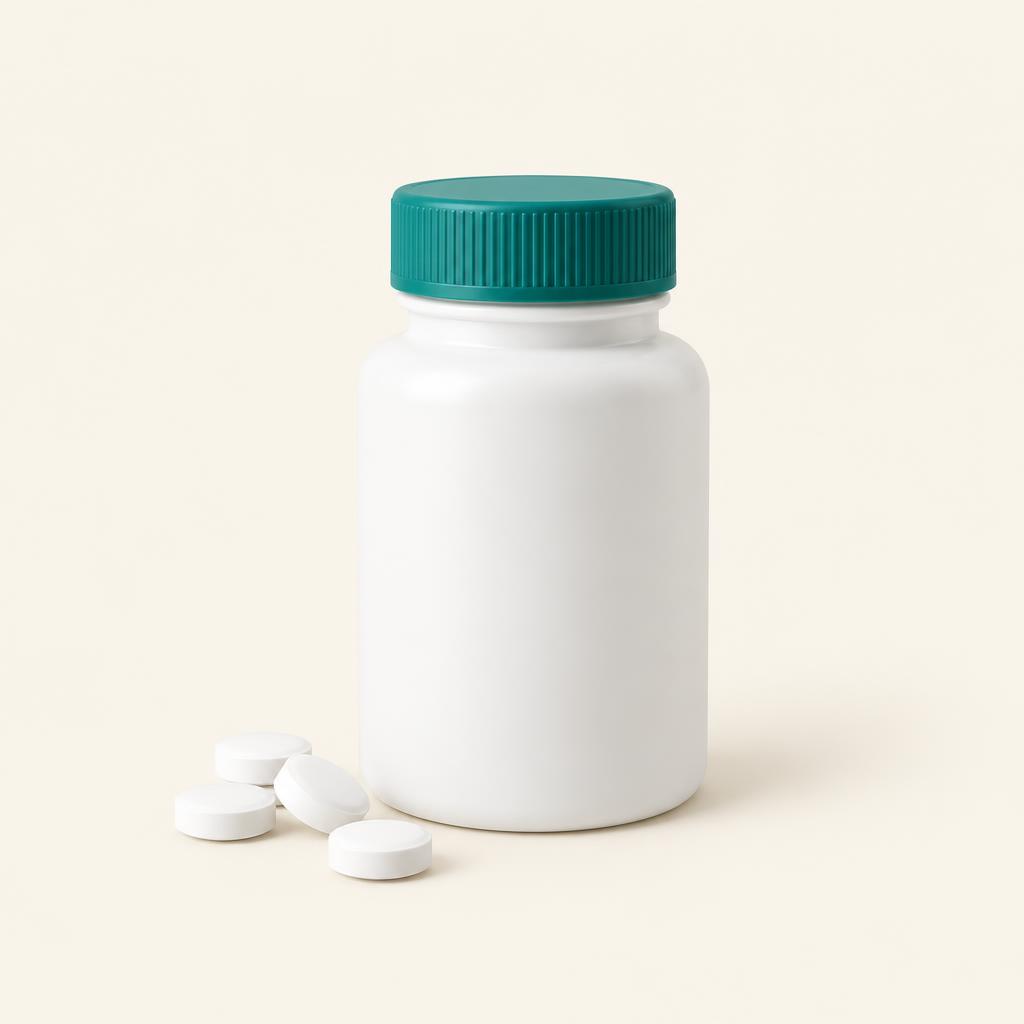 Plain white bottle with a teal cap beside small round white tablets on a cream background